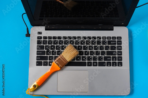 A carefully cleaning a dusty keyboard with a small brush.
