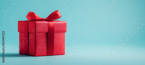 Gift Box with Red Ribbon on Blue Background