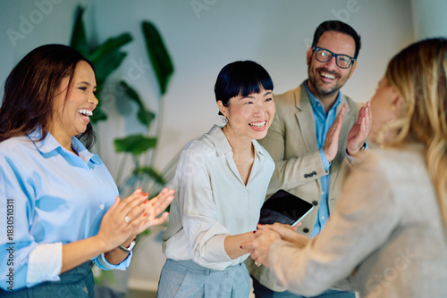 Tableau sur toile Multiracial business team congratulating diverse colleague with handshake and ap