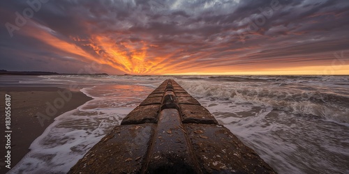 Fototapeta Naklejka Na Ścianę i Meble -  White marble statues atop a historic cathedral roof in an Italian piazza, emphasizing architectural preservation