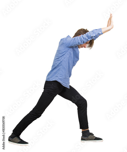 Photos Side view young male student pushing hard with both arms outstretched and palms up against an invisible barrier