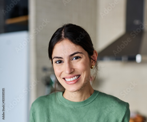 Portrait of a young woman with orange juice or smoothie in glass in the kitchen at home Free Download Portrait of a young woman with orange juice or smoothie in glass in the kitchen at home - GFXLoad