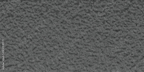 Close-up macro view of a uniform, granular dark gray textured surface with a consistent, rough, and matte finish, ideal for industrial or abstract backgrounds