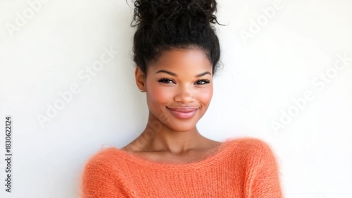 Portrait of a woman with a warm smile and updo