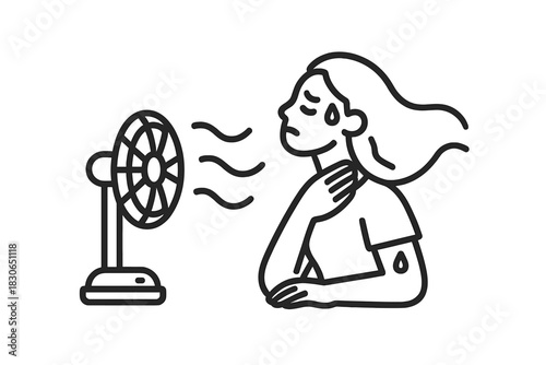 Person suffering heat exhaustion using small electric fan for temperature relief