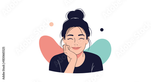 Portrait of a happy smiling young woman with a messy bun hairstyle resting her chin on her hand in a cute pose.