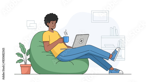 Young man relaxing on a bean bag chair, working on his laptop and enjoying a hot drink in a cozy home office setting.