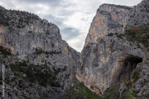 Wide canyon entrance framed by towering rocky cliffs