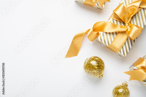 Merry Christmas and Happy Holidays greeting card, frame, border, banner. New Year. Golden Christmas decoration, ornaments and gifts, presents on white background. Xmas holiday festive theme.