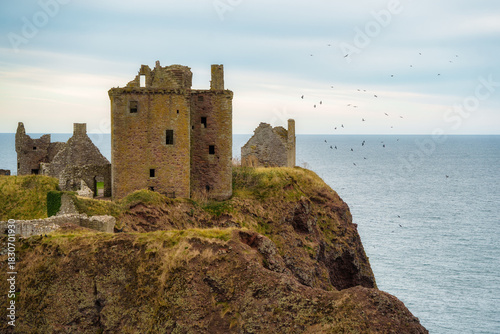 Dunnottar castle ruins standing on coastal cliff in scotland