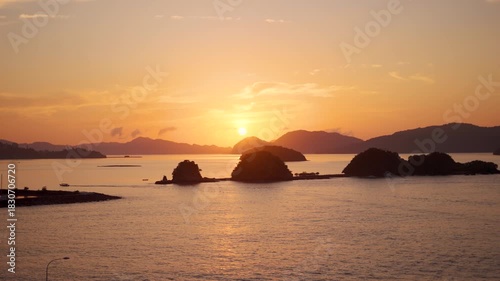 4K Scenic view of sunrise above the Langkawi island Archipelago in Malaysia with orange clouds in sky. Sun rising above the Strait of Malacca with little islands of Langkawi. Sunrise over sea at dawn.