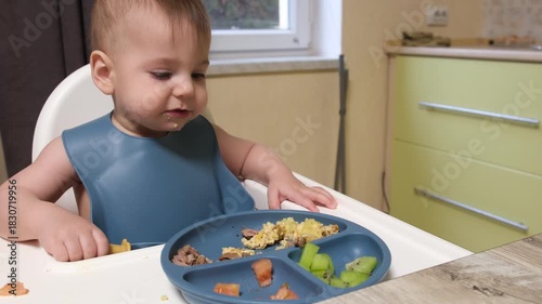 Baby Eating in High Chair with Divided Plate