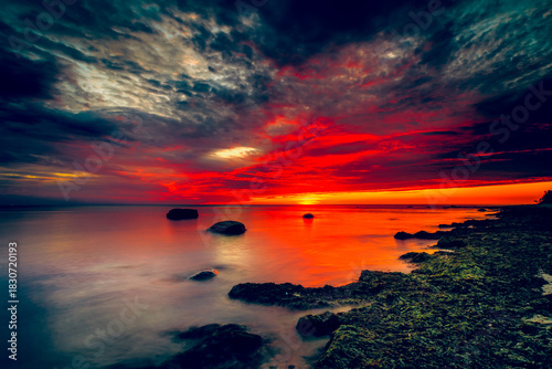 Fototapeta Naklejka Na Ścianę i Meble -  Vibrant Baltic Sea Sunset with water reflection on sandy beach in Lithuania