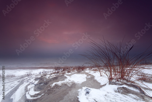 Fototapeta Naklejka Na Ścianę i Meble -  Winter Sunset Over the Baltic Dunes in Lithuania