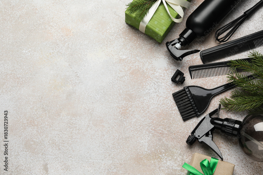 Obraz premium Hairdresser's tools and Christmas decor on color textured table, flat lay. Space for text