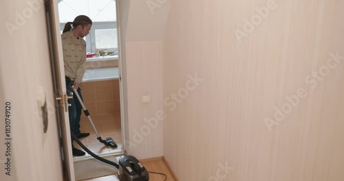 Man Vacuuming Floor at Home 4K 10-bit