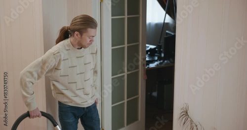 Man Vacuuming Floor at Home 4K 10-bit