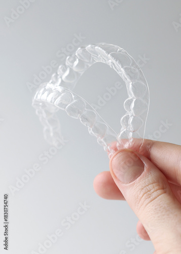 Aligners for straightening teeth on a light background. Vertical photo format