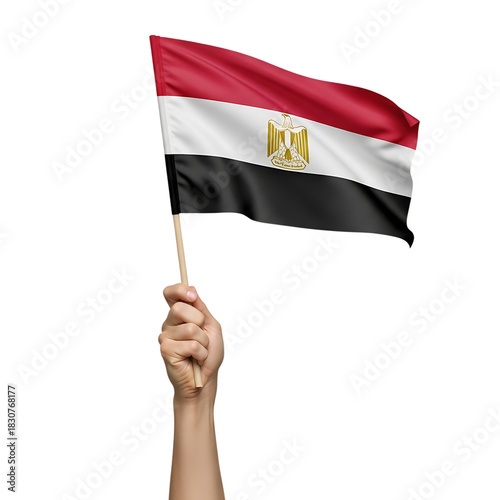 A raised hand firmly holds a flagpole with the Egyptian national flag waving, displaying horizontal red, white, and black stripes with a golden emblem, symbolizing Egypt's pride and celebration.