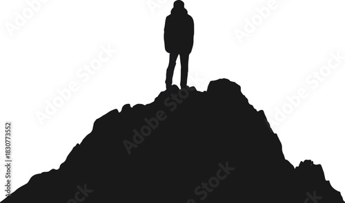 Silhouette of a person on a rocky mountain summit standing