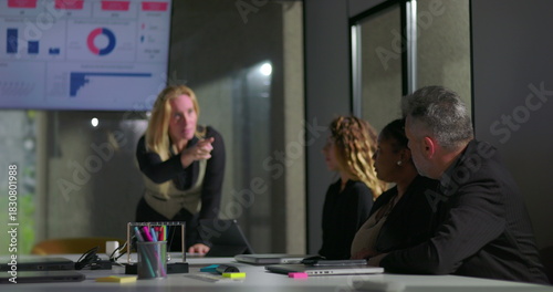 Female boss publicly scolding male employee during tense office meeting, man hides face in shame as colleagues look on, highlighting workplace conflict and humiliation