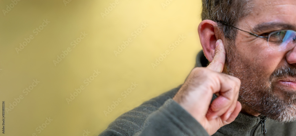 Fototapeta premium Man suffering ear pain or hearing loss concept