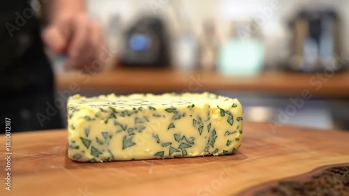 Herb butter on cutting board in kitchen. Chef preparing ingredients, suitable for cooking