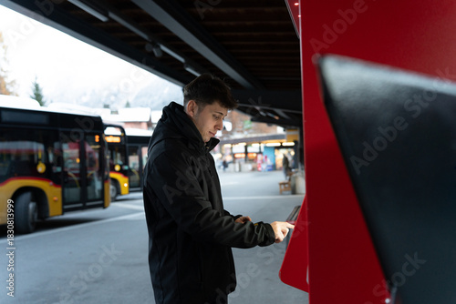 Man buying bus ticket from vending machine