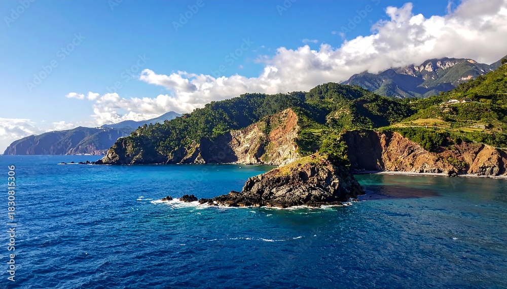 Fototapeta premium Dramatic coastal cliffs meet the azure sea under a bright sky.
