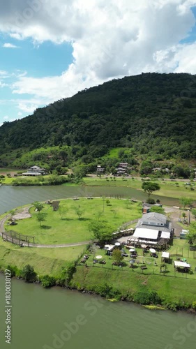 Aerial View of the Goio-Ên Recreation Area with Lake, Mountains and Buildings on a Sunny Day