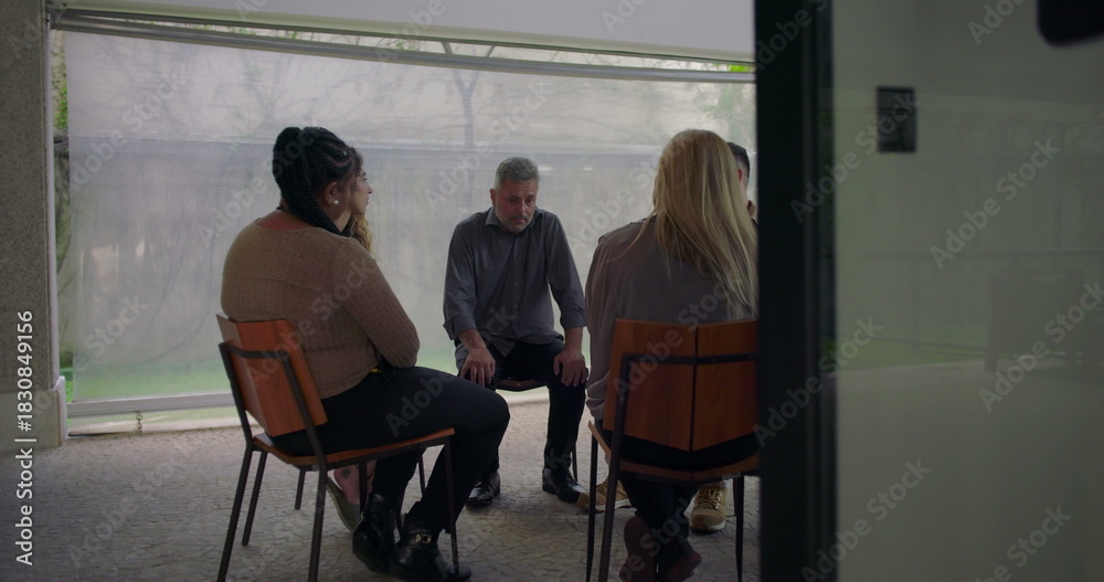 Fototapeta premium Emotional testimony shared by man in support group, heartfelt confession delivered with expressive body language in intimate circle setting