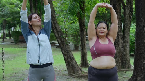 Plus size woman body positive self love exercising healthy living outdoor morning warmup stretching fitness exercise park pathway nature tree grass friend smiling natural light routine motivation