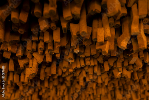 Violin bow Thin wooden sticks organized on a workbench for handcrafted production.