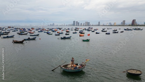Asia Vietnam,Da Nang beach - The traditional round fishing boats of Vietnamese fishermen - a contrast between the ancient life of the fishermen and the modern skyline of Da Nang city