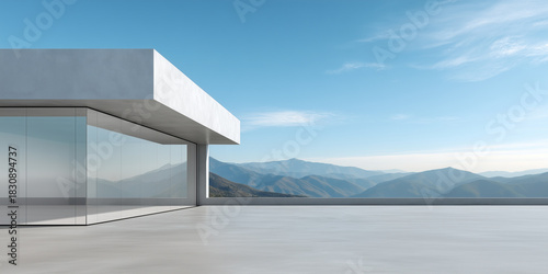 Modern structure with concrete floor and mountain backdrop. Building with large glass windows breathtaking panoramic view of majestic mountains and blue sky. Ideal background for product display.