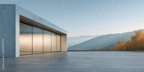 Contemporary building with large glass windows and clean concrete flooring, blending modern architecture with calm natural setting. Perfect background for product display, car park design, real estate