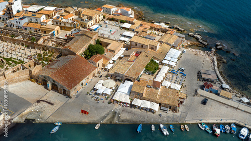 Fototapeta Naklejka Na Ścianę i Meble -  Aerial view of the historic center of the town of Marzamemi, in the province of Syracuse, Sicily, Italy. It is a small coastal village overlooking the crystalline waters of the Mediterranean Sea.
