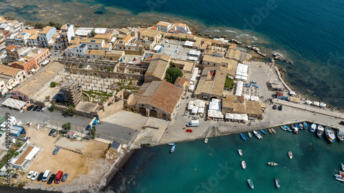 Fototapeta Naklejka Na Ścianę i Meble -  Aerial view of the historic center of the town of Marzamemi, in the province of Syracuse, Sicily, Italy. It is a small coastal village overlooking the crystalline waters of the Mediterranean Sea.