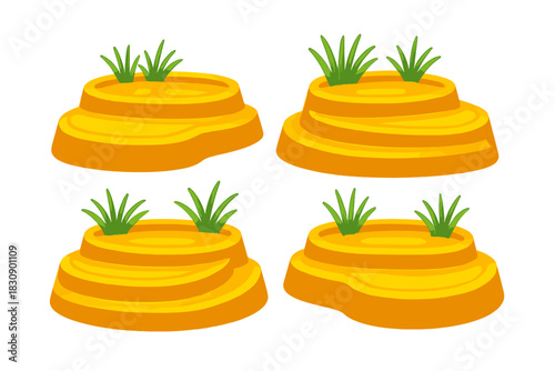 Set of four stylized tiered desert mounds with green grass tufts on top