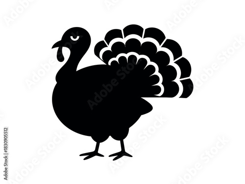 A silhouette of a proud turkey with its tail feathers fanned out stands as a symbol of Thanksgiving and the harvest season.