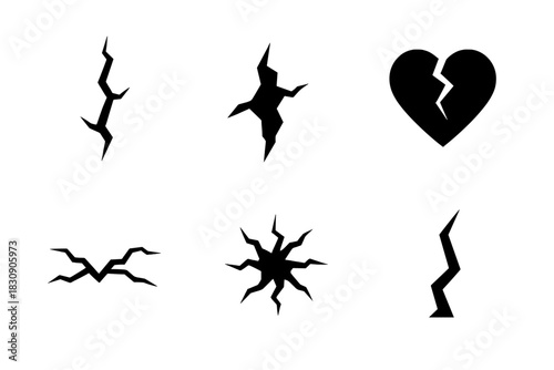 Set of abstract wall crack shapes and a fractured heart symbol representing damage and failure