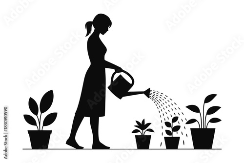 Silhouette of woman watering plants with watering can in garden