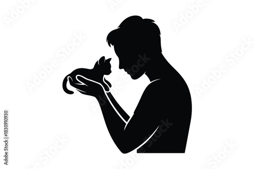 Silhouette of a person holding a kitten with love and care