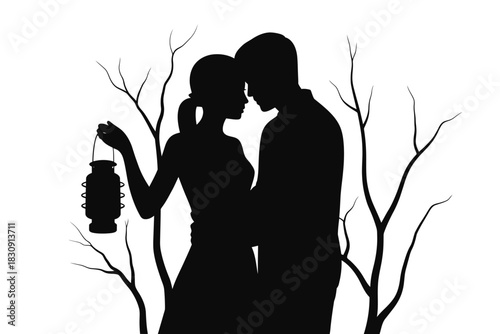 Silhouette of a romantic couple embracing with a lantern in nature