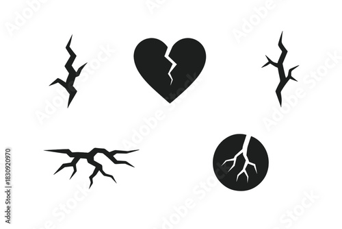 Black and white set of crack and damage shapes including a fractured heart