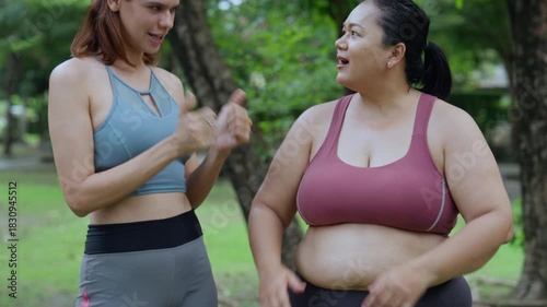 Plus size woman body positive self love exercising healthy living outdoor workout friends smiling park with trees and daylight casual activewear confidence mindful breath balanced posture and natural