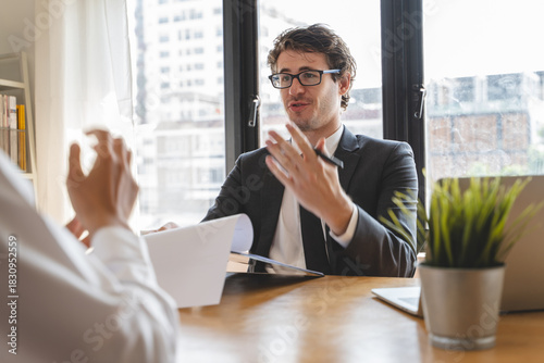 interviewer on the table asking question applicant in the office.