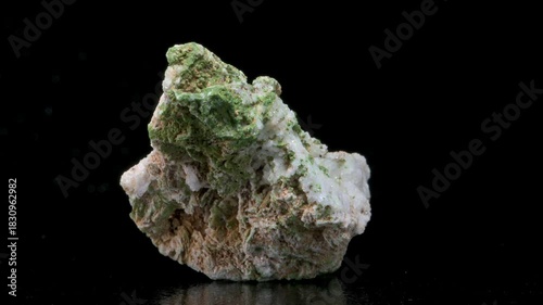 Green Pyromorphite {Pb5(PO4)3Cl } from Cumbria, UK, revolving slowly against a black background