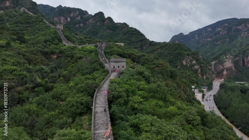 Great Wall of China winds through lush green mountains and forest landscape