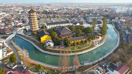 Aerial View of Ancient Town with Traditional Pagoda Tower and Winding River Through Urban Landscape